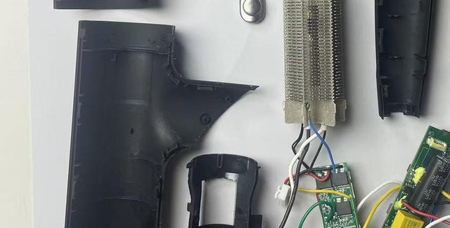 Teardown detail of a high-speed hair dryer showing the internal wiring harness, spade connectors, thermal insulation sleeve and control board - the connections between the power entry and the board
