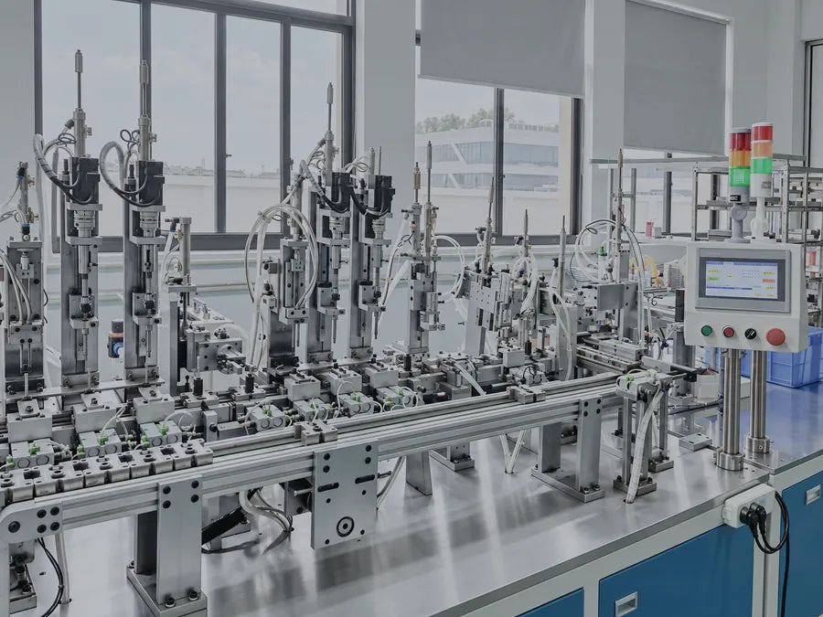 Automated assembly station with pneumatic rams, guide rails and a control panel