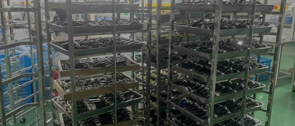 Racks of trays holding assembled units in an inter-stage holding area