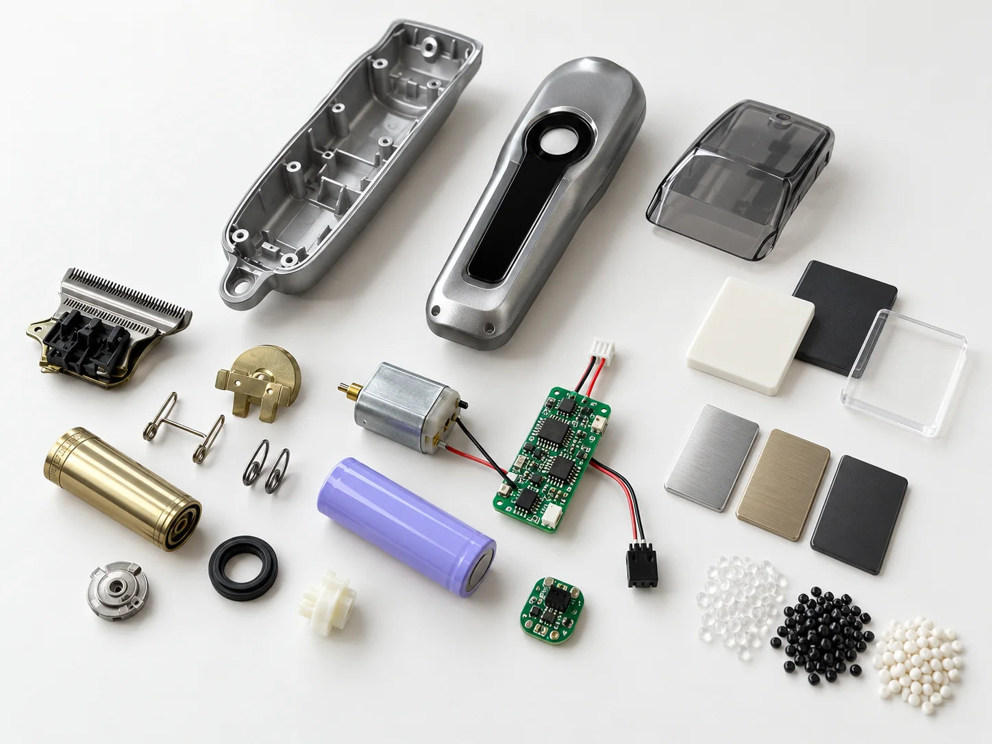 Components, PCBs and material colour chips for one product grouped on a bench