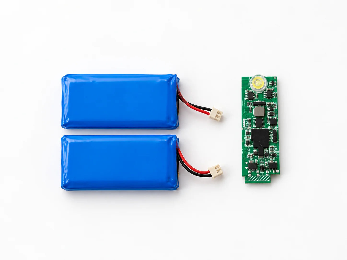 Two battery packs and their protection board removed from a device housing